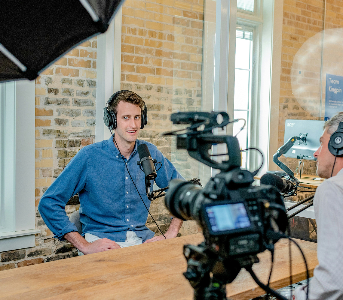 A camera pointed at a person with headphones on.